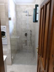 a shower with a glass door in a bathroom at Apartment Ksenija in Kotor