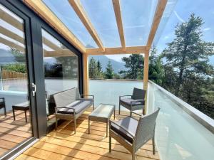 a room with chairs and a table on a balcony at Holiday Home SKY Chalet by Interhome in Imst
