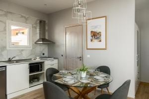 a kitchen with a dining room table and chairs at solarisuites in Mantoúkion