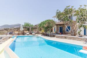 a villa with a swimming pool and a house at Windmill Bella Vista in Artemonas