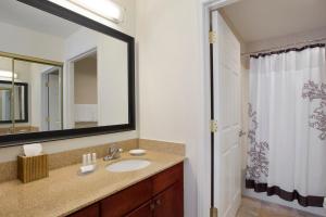 a bathroom with a sink and a mirror at Residence Inn Joplin in Joplin