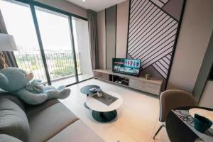 a living room with a teddy bear sitting on a couch at Millerz Cozy Home by GUESTONIC in Kuala Lumpur