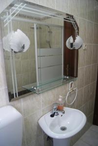 a bathroom with a sink and a mirror at 3 L's STAY in Castro Daire