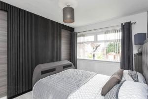 a bedroom with a white bed and a window at Modern home 10 mins to Belfast City in Belfast