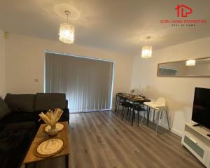 a living room with a couch and a table at Modern Spacious 4 Bed House By Icon Living Properties Short Lets & Serviced Accommodation Reading With Free Parking in Reading