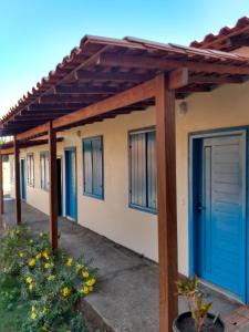 a pergola over the garage of a house at Pousada Pérola do Rio in Barreirinhas