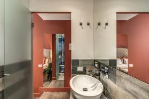 bagno con servizi igienici e specchio di Telier Tomacelli a Roma