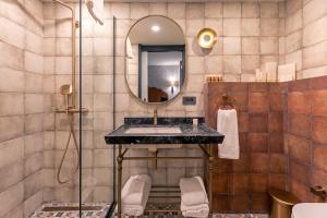 a bathroom with a sink and a mirror at Khai Karaköy in Istanbul