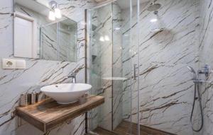 a bathroom with a sink and a glass shower at New Gudauri Redco Premium Apartments in Gudauri