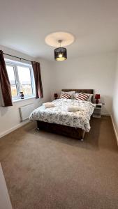 a bedroom with a bed and a window at The Bootle House in Litherland