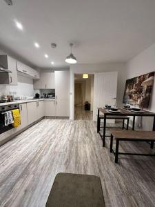 a large living room with a table and a kitchen at The Bootle House in Litherland