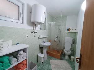 a small bathroom with a sink and a toilet at Apartment Lilac Sarajevo in Sarajevo +11 photos