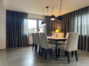 a dining room with a table and chairs at CASA LOBO Charmantes Ferienhaus im Allgäu in Leutkirch im Allgäu