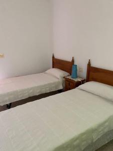 a room with two beds and two night stands at Casa Costacabana Mar in La Cañada de San Urbano