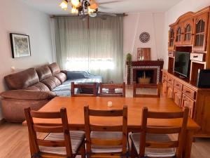a living room with a table and a couch at Casa Costacabana Mar in La Cañada de San Urbano