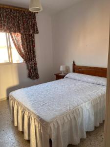 a bedroom with a white bed with a window at Casa Costacabana Mar in La Cañada de San Urbano