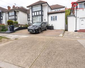 a black car parked in front of a house at Arch-View Apartment 1 By Icon Living Properties Short Lets & Serviced Accommodation Wembley in London