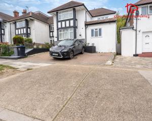 a black car parked in front of a house at 1 Bedroom Arch-View Apartment 2 By Icon Living Properties Short Lets & Serviced Accommodation With Free Parking in London