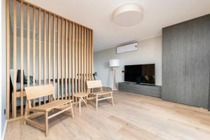 a living room with a table and chairs and a television at Serenity Villa in Rohuneeme