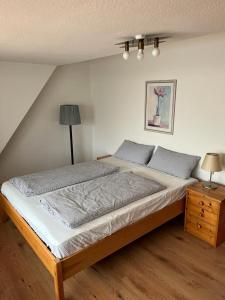 a bedroom with a large bed and a night stand at Nord Haus in Kiel