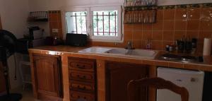 a kitchen with a sink and a counter top at Villa les chênes in Bargemon