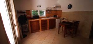 a kitchen with wooden cabinets and a table and a sink at Villa les chênes in Bargemon