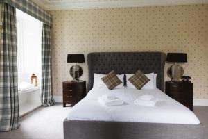 a bedroom with a bed with two towels on it at Greshornish House Hotel in Edinbane