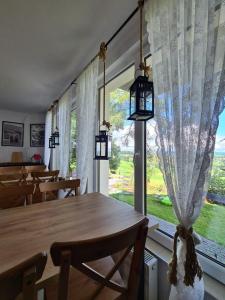 a dining room with a table and a large window at Baca in Bukowina Tatrzańska