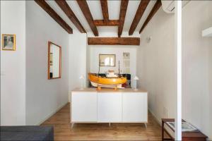 a bathroom with a yellow tub on top of a cabinet at Cà 3 Leoni - Romantic House in the heart of Venice in Venice