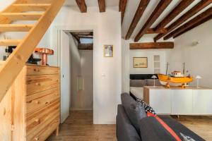 a living room with a couch and a table with a boat on it at Cà 3 Leoni - Romantic House in the heart of Venice in Venice +18 photos