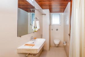 a bathroom with a sink and a toilet at J Hotel and Banquets in Mumbai