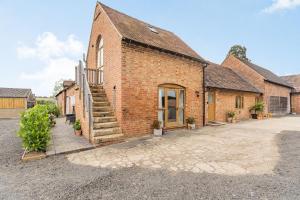 a brick building with a staircase outside of it at The Granary at Lane End Farm in Evesham