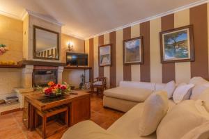 a living room with a couch and a fireplace at Acogedora finca con piscina en Lloseta in Lloseta