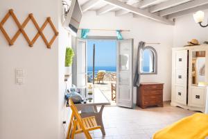 a bedroom with a view of the ocean at Kimolos in Sikinos