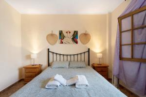 a bedroom with a bed with two towels on it at Apartment Colina Vista in Los Cristianos +14 photos