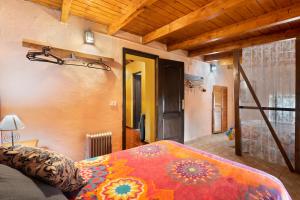 a bedroom with a bed with a colorful blanket at Casa Azul del Roque Negro in Santa Cruz de Tenerife