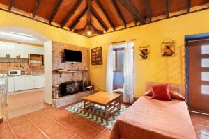 a living room with a bed and a fireplace at Casa Azul del Roque Negro in Santa Cruz de Tenerife