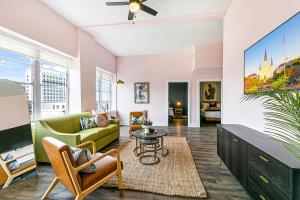 a living room with a couch and a tv at California Building by Hosteeva in New Orleans