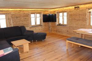 uma sala de estar com um sofá e uma televisão em Panoramahof Monika Kennerknecht em Akams