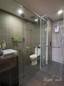 a bathroom with a shower with a toilet and a sink at Aeropod Sovo Wi-Fi&Netflix 5min From Airport in Kota Kinabalu