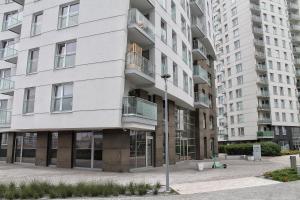 an apartment building with a street light in front of it at Golden Apartments Gdansk&P29 in Gdańsk