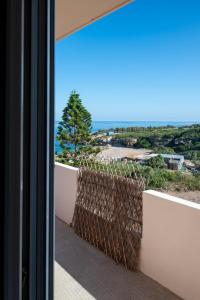 a view of the ocean from the balcony of a house at Naiada Stomio-B apartment in Katsímbalis