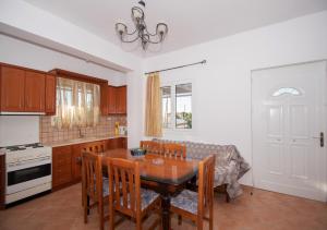 a kitchen with a dining room table and a couch at Shoreline Drive Beach House in Makris Gialos