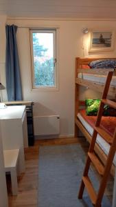 a room with two bunk beds and a window at Tofte Guesthouse nära hav, bad och Marstrand in Lycke