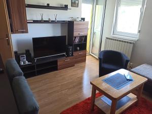 a living room with a tv and a coffee table at Apartman MM , Banja Luka, Wi-Fi free,parking free in Banja Luka