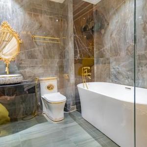 a bathroom with a tub and a toilet and a sink at ENJOY HOTEL 2 in Ho Chi Minh City
