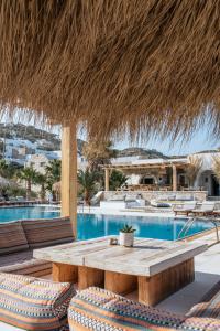a patio with a table and chairs and a pool at Yialos Ios Hotel in Ios Chora