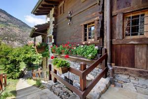 a house with flowers on the side of it at Chalet 1175 - Grand-haury in Arvier