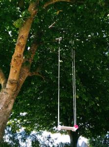 a pair of swings hanging from a tree at CosyPlace; close to beach, nature, train, grocery in Köpingebro