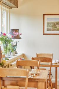 a dining room with a table and chairs and a window at The Old Coach House in Ripon